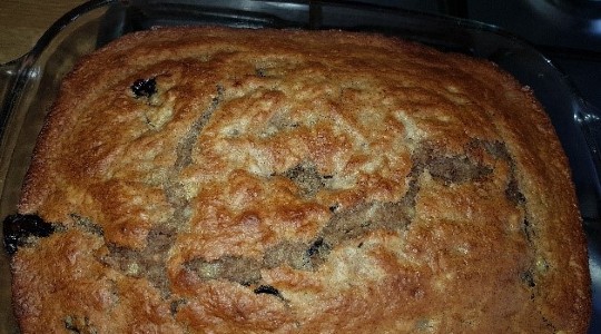 Loaf of homemade golden brown banana bread with blueberries