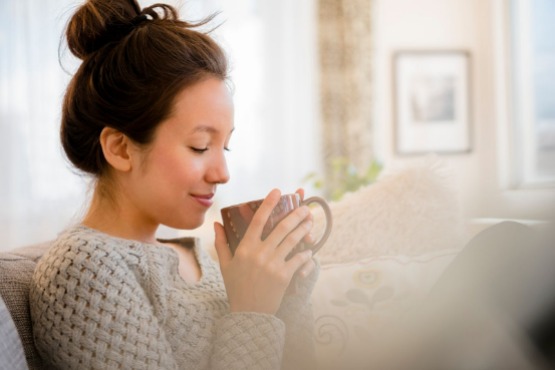 woman relaxing on the sofa with a cup of tea