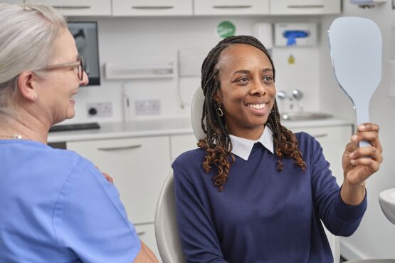 client checks teeth in mirror