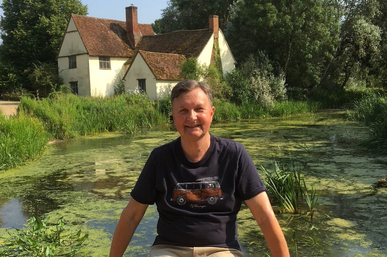 man posing for a picture outside garden