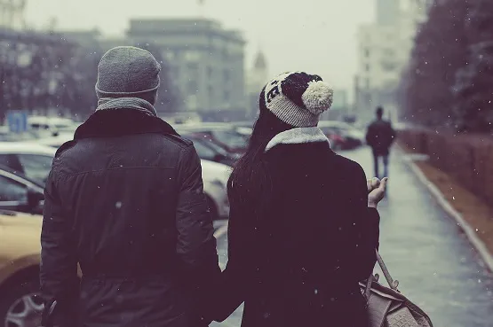 male and female couple walking outdoors in winter