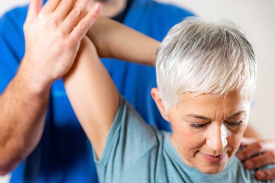 shoulder stretches guided by a physio