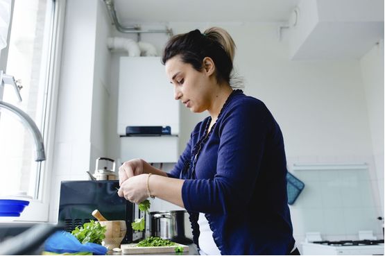 a woman cooking in the kitchen
