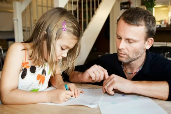adult watching a child draw