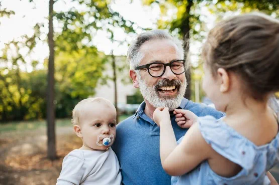 child using dummy with parents