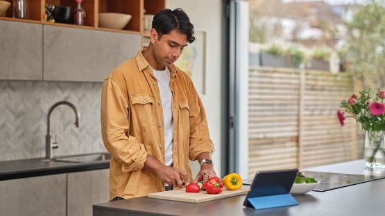 man cooking a recipe using ipad
