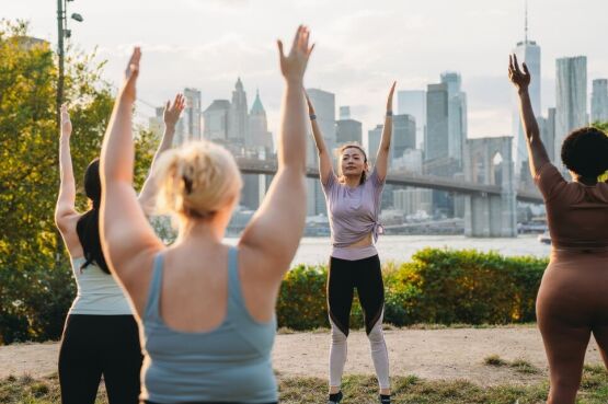 group doing yoga in the park