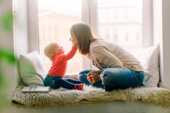 A mother and baby playing