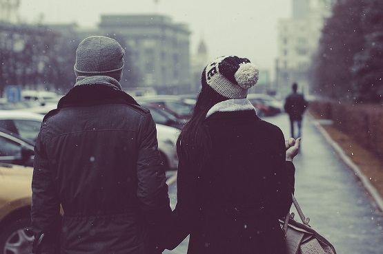 male and female couple walking outdoors in winter
