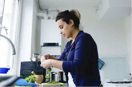 a woman cooking in the kitchen