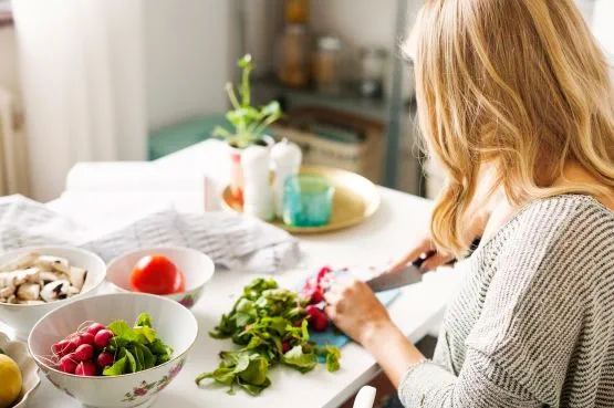 woman preparing healthy fresh food in her kitchen