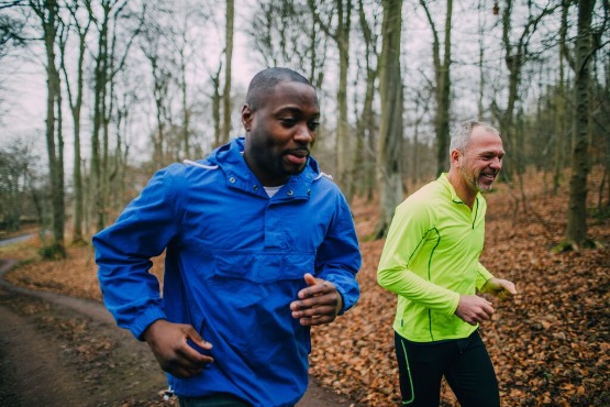 two men running in the woods