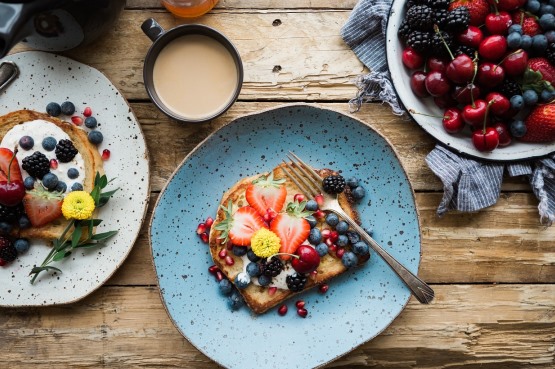 plates of fresh fruit and fruit on toast