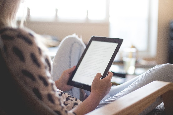 a woman reading on a tablet