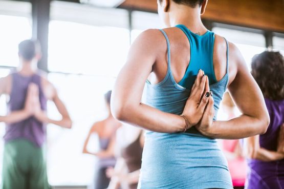 people doing a back stretch in a yoga class