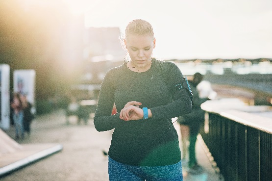 woman checking her smart watch outdoors