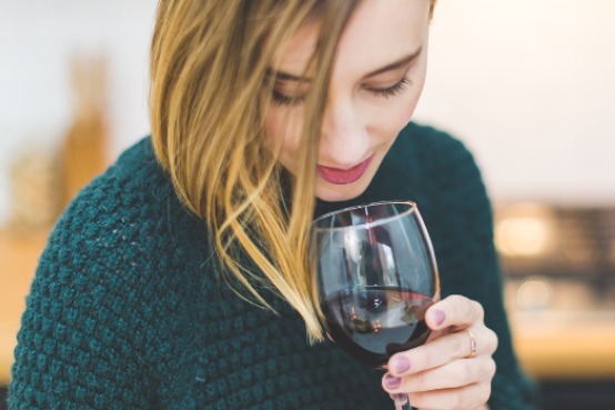 woman holding a glass of wine