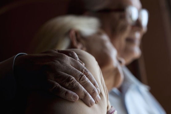 an older couple hugging