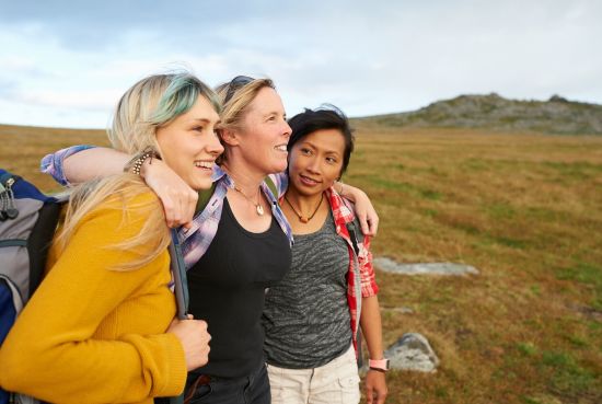 A group of people outdoors smiling