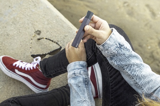 a person holding an e-cigarette
