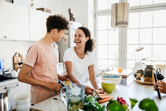 two people cooking at home