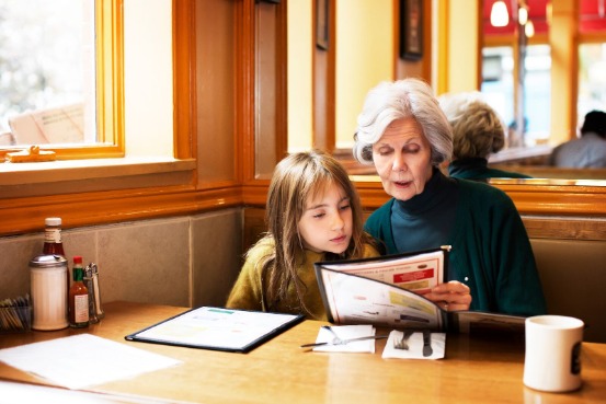 older woman and child looking at restaurant menu
