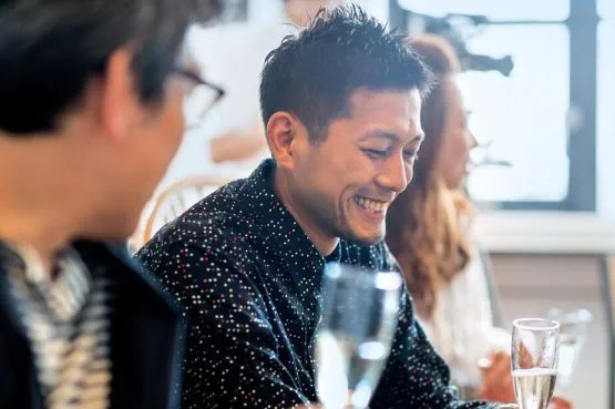 A man drinking a glass of wine