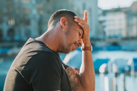 man holding his head in hands