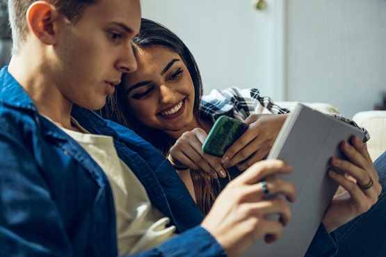 A young couple looking at a tablet