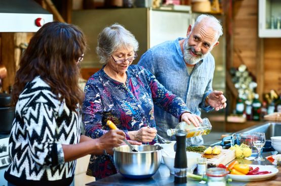 three older people cooking together