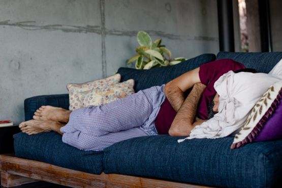 man sleeping on a sofa