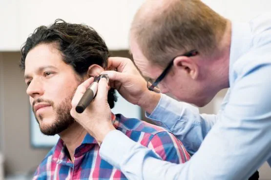 doctor examining a person's ear