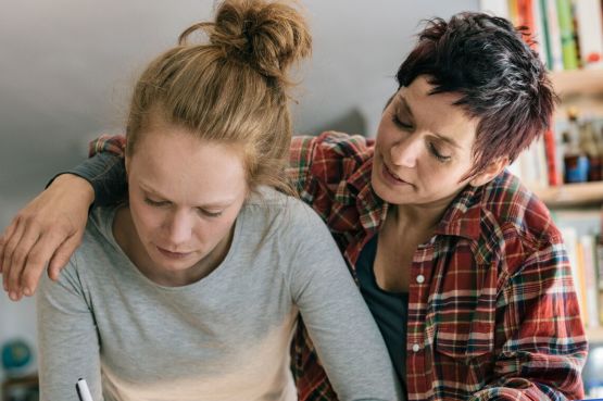 two people making notes