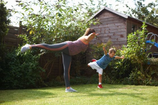 woman and child exercising in the garden