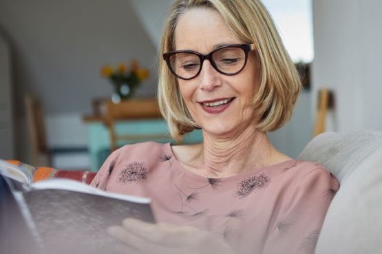 person reading a book at home