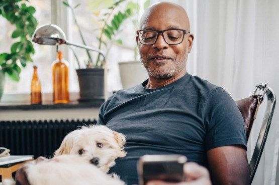 man with glasses reading on mobile