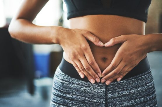 woman holding her hand over her belly