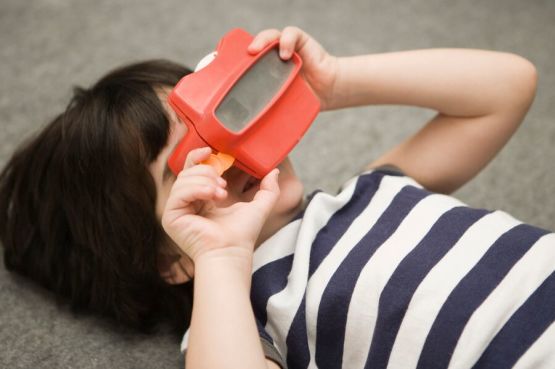 Child playing with a slide viewer