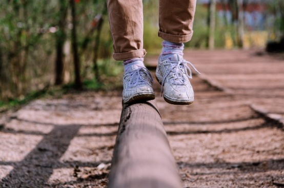 person balancing on a log