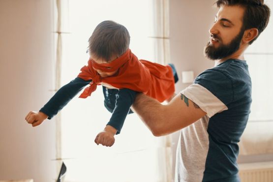 parent and child playing together indoors