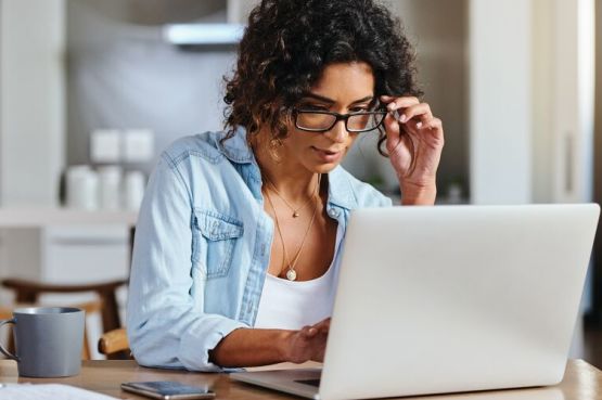 person sitting at a table with a laptop