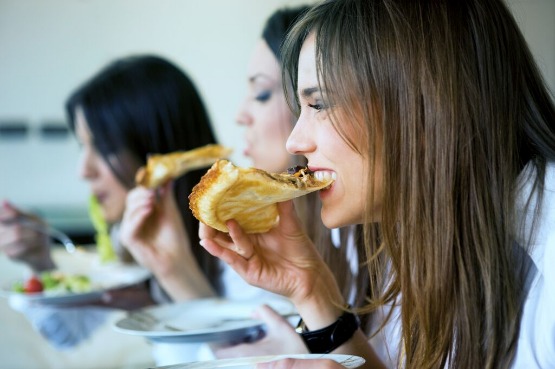 group of people eating pizza