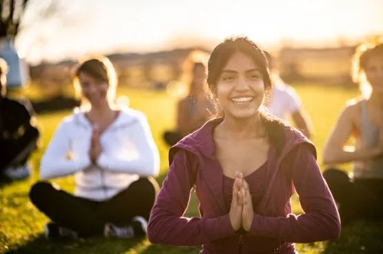 a group of people in a yoga class outdoors