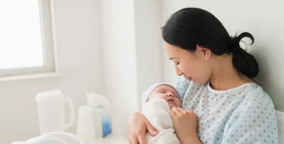 woman holding a baby in the hospital