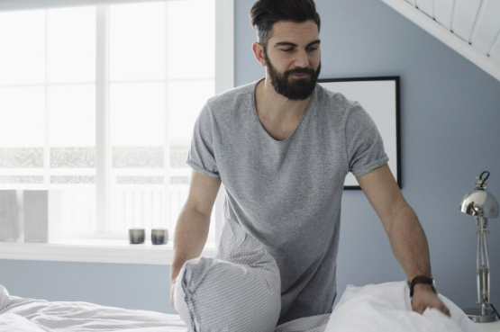 an adult changing bedsheets