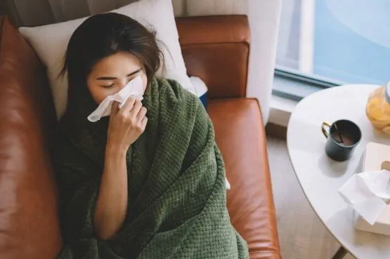 person lying on sofa feeling unwell
