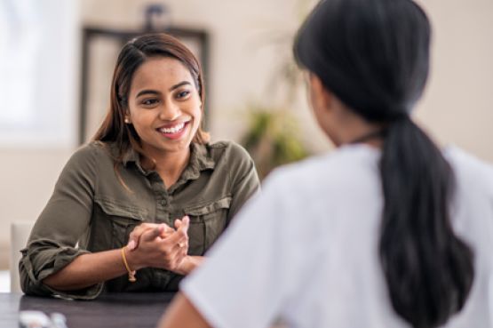 two people chatting and smiling