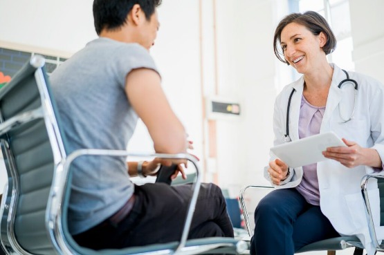 doctor and patient smiling in a consultation
