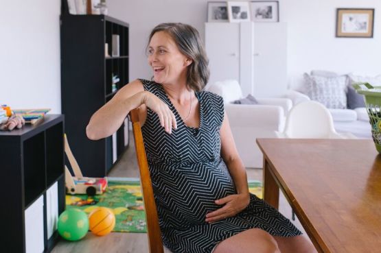 happy pregnant person at home