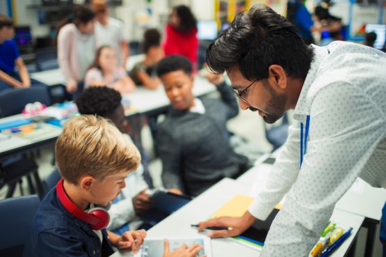 A teacher talking to a child